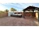 Private backyard showcasing a hot tub, brick pavers, a shed, and a charming pergola, perfect for relaxation at 2922 Tranquil Brook Ave, Henderson, NV 89044
