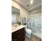 A bathroom featuring a modern shower, with a sink and vanity nearby at 2922 Tranquil Brook Ave, Henderson, NV 89044