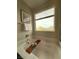 A close up of the relaxing soaking tub with wooden shelf and a view to the outside window at 2922 Tranquil Brook Ave, Henderson, NV 89044