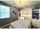 Stylish bedroom with a Murphy bed, built-in shelving, and modern lighting at 2922 Tranquil Brook Ave, Henderson, NV 89044