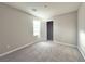 This bedroom has neutral walls, carpet floors, a window, and an open closet at 2922 Tranquil Brook Ave, Henderson, NV 89044
