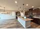 Modern kitchen features a large center island with a marble countertop, stainless steel appliances, and lots of cabinet space at 2922 Tranquil Brook Ave, Henderson, NV 89044