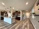A view of the kitchen with stainless steel appliances, a large island, and pendant lights at 2922 Tranquil Brook Ave, Henderson, NV 89044