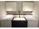 Practical laundry room featuring appliances, cabinet storage, and sink at 2922 Tranquil Brook Ave, Henderson, NV 89044