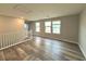 Spacious living room featuring wood-like floors and ample natural light from multiple windows at 2922 Tranquil Brook Ave, Henderson, NV 89044