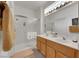 Bright bathroom featuring a glass shower, double sinks, and ample counter space at 2969 Sumter Valley Cir, Henderson, NV 89052