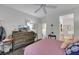 Comfortable bedroom with ceiling fan, wood dresser, and doorway to the bathroom at 2969 Sumter Valley Cir, Henderson, NV 89052
