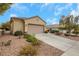Charming single story home featuring a tile roof, desert landscaping, and an attached two car garage at 2969 Sumter Valley Cir, Henderson, NV 89052
