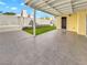 Covered patio with tiled flooring overlooks artificial turf for low-maintenance outdoor living at 3308 Paragon Dr, Las Vegas, NV 89117