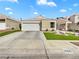 Charming single-story home featuring a two-car garage, well-maintained lawn, and a classic desert landscape at 3308 Paragon Dr, Las Vegas, NV 89117