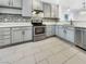 Bright kitchen with gray cabinets, modern appliances, and stylish tile flooring for cooking enjoyment at 3308 Paragon Dr, Las Vegas, NV 89117