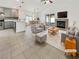 Open-concept living room featuring vaulted ceilings, tile floors, fireplace, and access to the backyard at 3308 Paragon Dr, Las Vegas, NV 89117