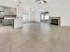 Spacious living room with vaulted ceilings, fireplace, tile floors, and sliding doors to the backyard at 3308 Paragon Dr, Las Vegas, NV 89117