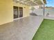 A covered patio with tile flooring and artificial turf provides a great outdoor space at 3308 Paragon Dr, Las Vegas, NV 89117