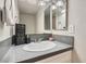 Bathroom with white sink, light countertop, mirror, and a cute sign on the counter at 3609 Laguna Del Sol Dr, Las Vegas, NV 89121