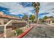 Welcoming community entrance with a beautifully designed sign and palm trees, creating an inviting atmosphere at 3609 Laguna Del Sol Dr, Las Vegas, NV 89121