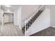 Inviting home entryway with modern gray floors, staircase with gray carpet, and freshly painted walls at 3609 Laguna Del Sol Dr, Las Vegas, NV 89121