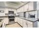 Bright kitchen features stainless steel appliances, light countertops, and white cabinets at 3609 Laguna Del Sol Dr, Las Vegas, NV 89121