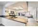Modern kitchen featuring white cabinets, stainless steel appliances, and a breakfast bar overlooking the living area at 3609 Laguna Del Sol Dr, Las Vegas, NV 89121