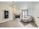 Cozy living room with a stone fireplace, recessed lighting, and ample natural light from the large window at 3609 Laguna Del Sol Dr, Las Vegas, NV 89121
