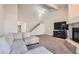Spacious living room features a staircase, fireplace, and cozy sectional sofa at 3609 Laguna Del Sol Dr, Las Vegas, NV 89121