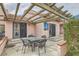 Charming outdoor patio area with pergola, brick accents, and outdoor seating for relaxing and entertaining at 3609 Laguna Del Sol Dr, Las Vegas, NV 89121