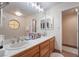 Bathroom featuring double sinks, tile countertops, and a large mirror at 4097 Nook Way # A, Las Vegas, NV 89103