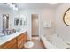 Bathroom featuring double sinks, soaking tub, and tile floors at 4097 Nook Way # A, Las Vegas, NV 89103