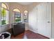 Bedroom featuring dark dresser, hardwood floors, and arched windows for natural light at 4097 Nook Way # A, Las Vegas, NV 89103