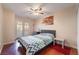Inviting bedroom with wood floors, complemented by a queen bed, ceiling fan, and natural light at 4097 Nook Way # A, Las Vegas, NV 89103