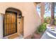 Close-up of a charming front door with security features, desert landscaping, and well-maintained walkway at 4097 Nook Way # A, Las Vegas, NV 89103
