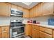 Well-equipped kitchen with stainless steel appliances, oak cabinetry, and ample counter space at 4097 Nook Way # A, Las Vegas, NV 89103