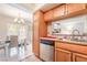 Open kitchen view with tile floors and stainless steel appliances overlooking dining area at 4097 Nook Way # A, Las Vegas, NV 89103