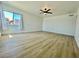 Bright bedroom featuring vinyl floors, a large window, and a ceiling fan at 4324 El Conlon Ave, Las Vegas, NV 89102
