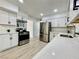 Spacious kitchen with stainless steel appliances, white cabinets, and modern countertops at 4324 El Conlon Ave, Las Vegas, NV 89102