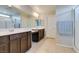 Bathroom featuring double sink vanity, tile floors, and large mirror with glass shower at 4642 Chirping St, North Las Vegas, NV 89031