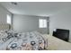 Bright bedroom featuring neutral tones, carpet flooring, and large windows for natural light at 4642 Chirping St, North Las Vegas, NV 89031