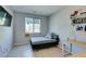 Bright bedroom with a twin bed, desk, and shelving at 4642 Chirping St, North Las Vegas, NV 89031