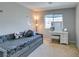 Cozy bedroom featuring a stylish daybed with decorative pillows and a well-lit vanity area with a mirror at 4642 Chirping St, North Las Vegas, NV 89031