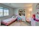 Charming bedroom with pink accents, including a playful bed and delightful decorative items for youthful appeal at 4642 Chirping St, North Las Vegas, NV 89031
