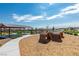 Community park featuring a playground with climbing structure, picnic pavilion, and manicured walkway at 4642 Chirping St, North Las Vegas, NV 89031