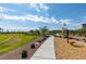 Community park with lush green space, walking paths, workout equipment, and picnic pavilion at 4642 Chirping St, North Las Vegas, NV 89031