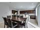 Open dining area featuring a dark wood table, seating for six, and tile flooring at 4642 Chirping St, North Las Vegas, NV 89031