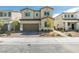 Two story home featuring a two car garage, desert landscaping and neutral colored stucco at 4642 Chirping St, North Las Vegas, NV 89031
