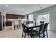Open-concept kitchen with a dark wood dining table and views to stainless steel appliances at 4642 Chirping St, North Las Vegas, NV 89031