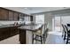 Well lit kitchen features dark wood cabinetry, granite countertops, and stainless steel appliances at 4642 Chirping St, North Las Vegas, NV 89031