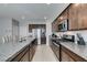 Spacious kitchen featuring granite countertops, stainless steel appliances and dark wood cabinetry at 4642 Chirping St, North Las Vegas, NV 89031
