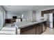 Open concept kitchen and living area with granite counters, stainless appliances, and tile flooring at 4642 Chirping St, North Las Vegas, NV 89031