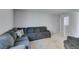 Spacious living area with plush sectional sofa, soft carpet, and an open layout for versatile living at 4642 Chirping St, North Las Vegas, NV 89031