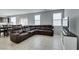 Spacious living room featuring a large brown leather sectional sofa at 4642 Chirping St, North Las Vegas, NV 89031